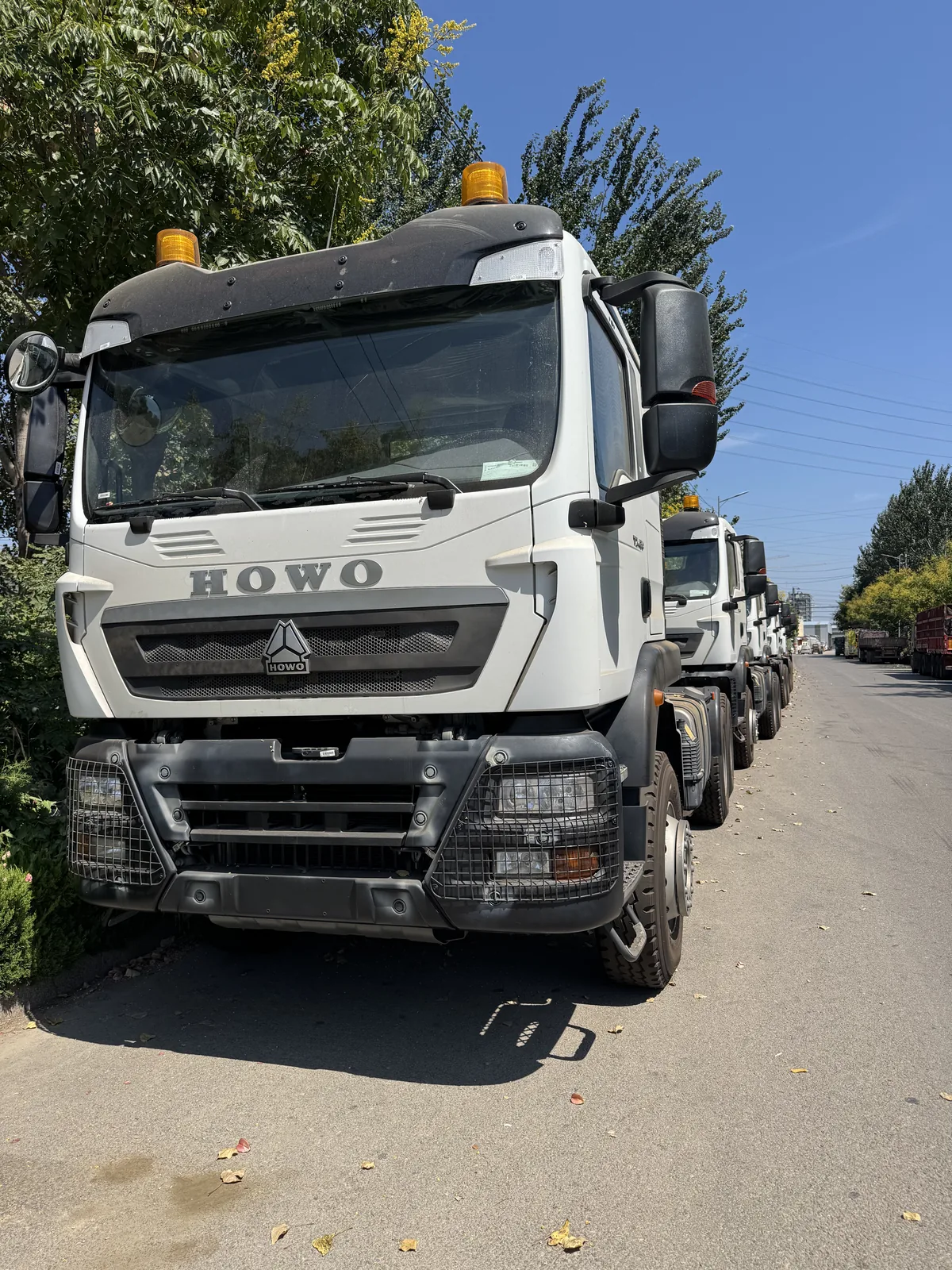Front view of a white HOWO tractor truck, showing the cab and front bumper