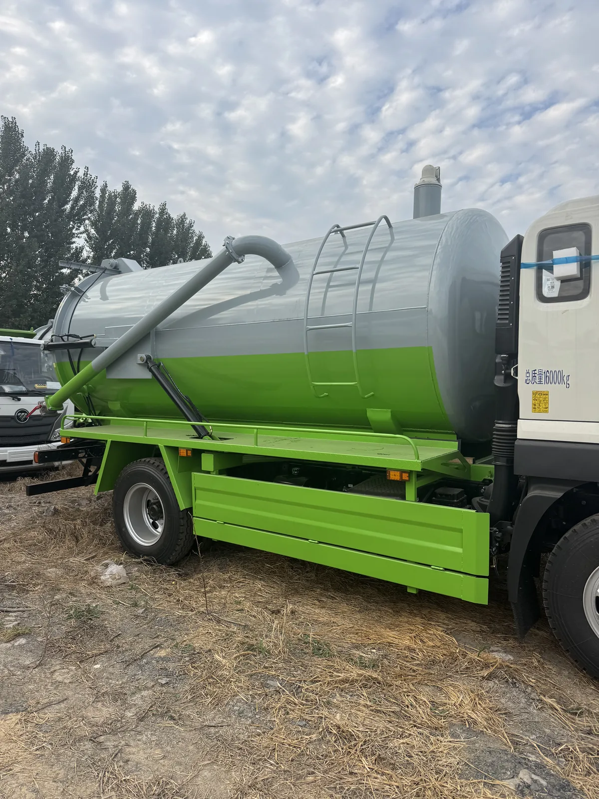 Side view of a sanitation tank vehicle