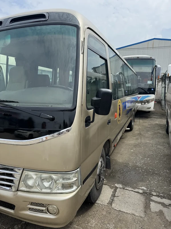 Coaster-type minibus, front and side view; brand unconfirmed